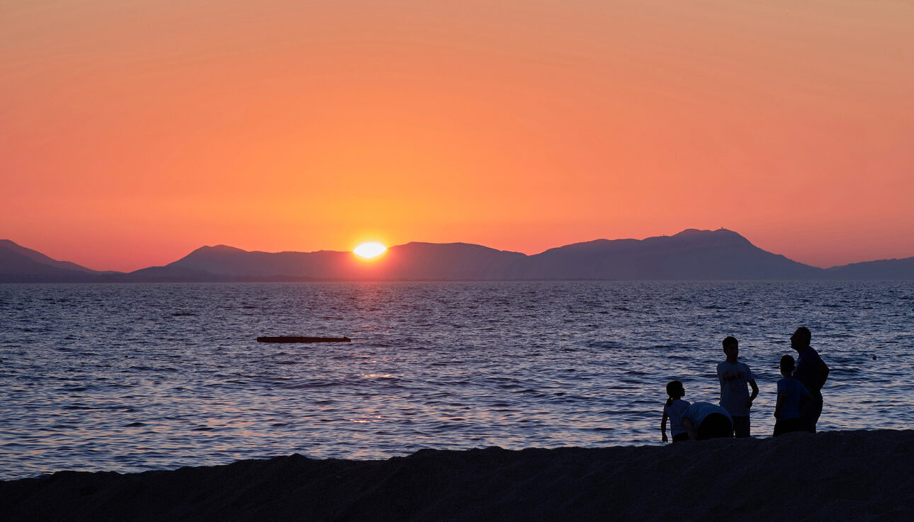 Family on the beach in Greece